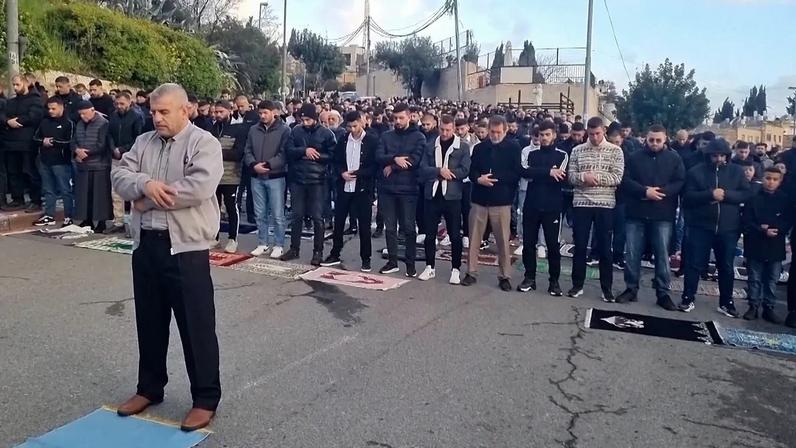 Worshippers praying in street as part of Eid al-Fitr observations