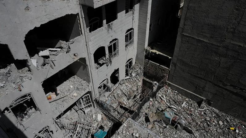 A building is damaged after a nearby residential building was hit in an overnight US-Israeli strike in Tehran, Friday, March 27, 2026.