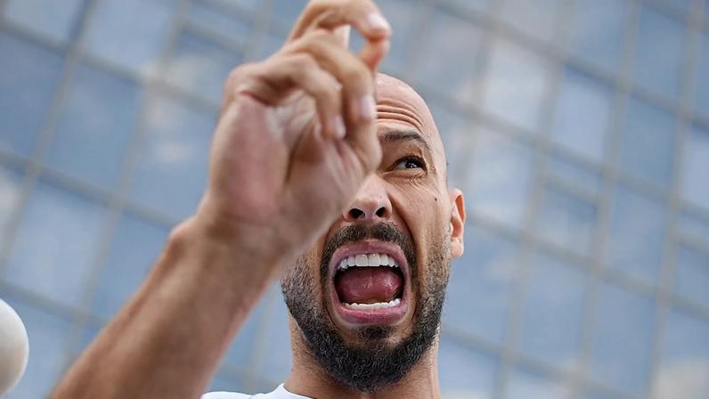 Andrew Tate speaks to media outside the Bucharest Tribunal after being placed under house arrest, 22 August, 2024