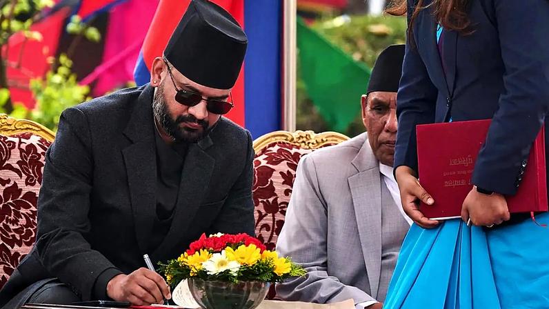 Nepal's youngest Prime Minister Balendra Shah signs documents after taking the oath of office at the Presidential building in Kathmandu, 27 March, 2026