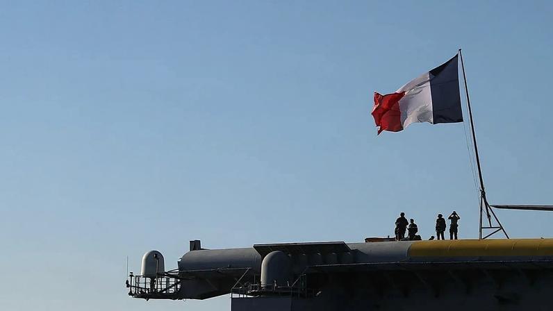 French Navy officers stand on board the aircraft carrier Charles de Gaulle off the suburb of Faliro, Athens, Thursday 24 March 2022.