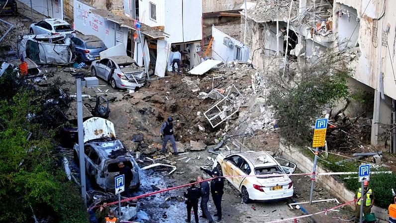 Israeli security and rescue forces respond at the site of an Iranian missile strike in Tel Aviv, 24 March 2026
