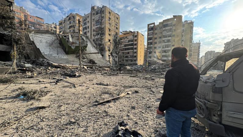 A man inspects damage buildings after an Israeli strike on Beirut's southern suburbs