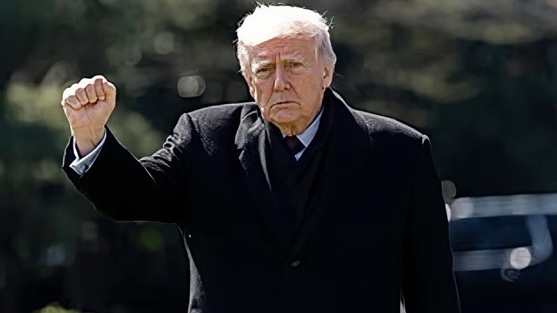 President Donald Trump pumps his fist as he walks to depart on Marine One from the South Lawn of the White House, Wednesday, March 18, 2026, in Washington.
