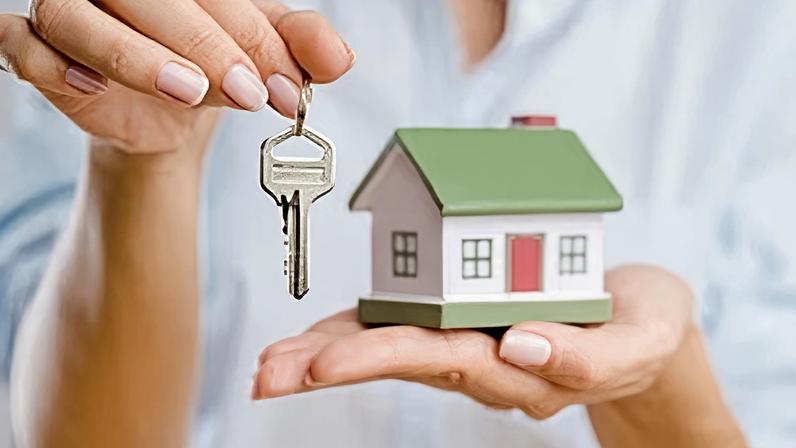 A miniature house and a house key