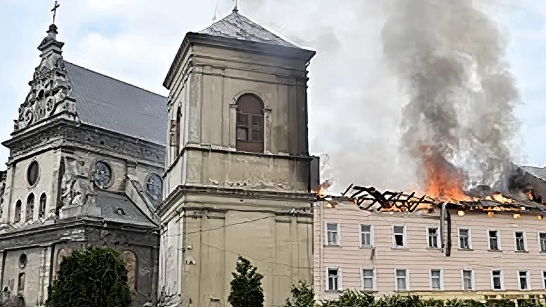 Fire and smoke rise above the city center following Russia's drone attack in Lviv, Ukraine, Tuesday, March 24, 2026.