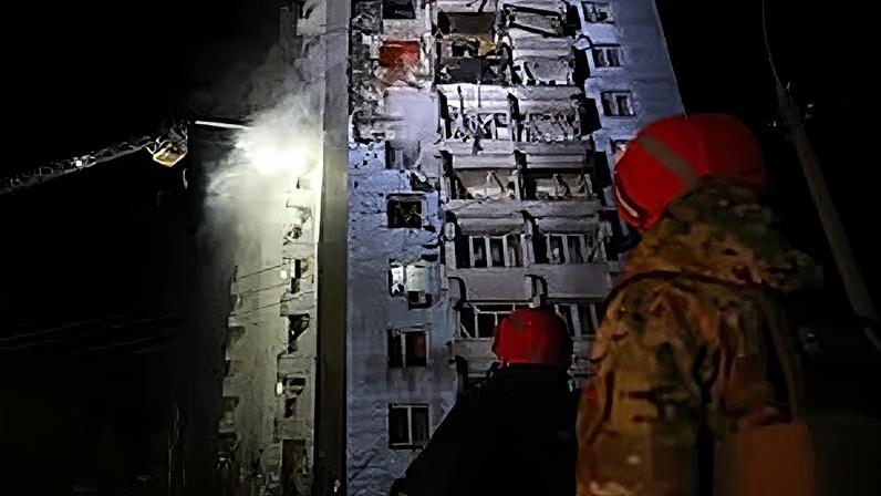 Rescue workers try to put out a fire of a residential building burning after a Russian drone attack on Zaporizhzhia, Ukraine, Tuesday, March 24, 2026.