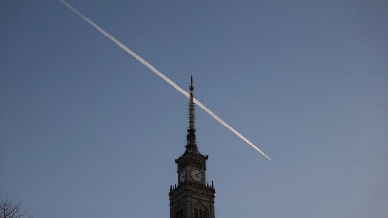 A plane trail is seen in the sky above the Palace of Culture and Science in Warsaw, Poland, October 28, 2024. REUTERS/Kacper Pempel