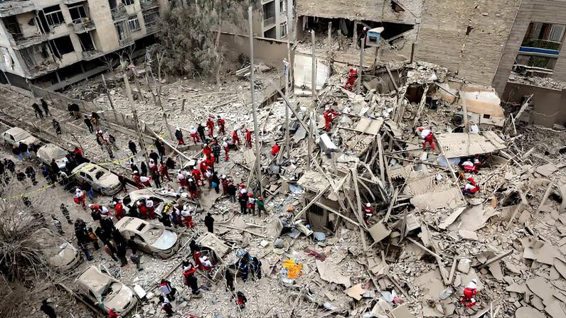 Emergency personnel work at the site of a strike on a residential building, amid the U.S.-Israeli conflict with Iran, in Tehran, Iran, March 16, 2026. Majid Asgaripour/WANA (West Asia News Agency) via REUTERS