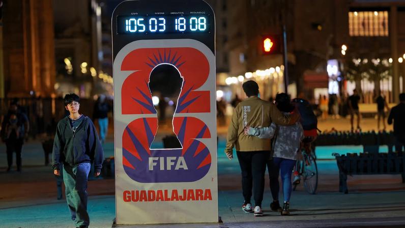 People walk past a countdown clock for the FIFA World Cup 2026 on a street, in Guadalajara, Mexico, February 25, 2026. REUTERS/Jose Luis Gonzalez