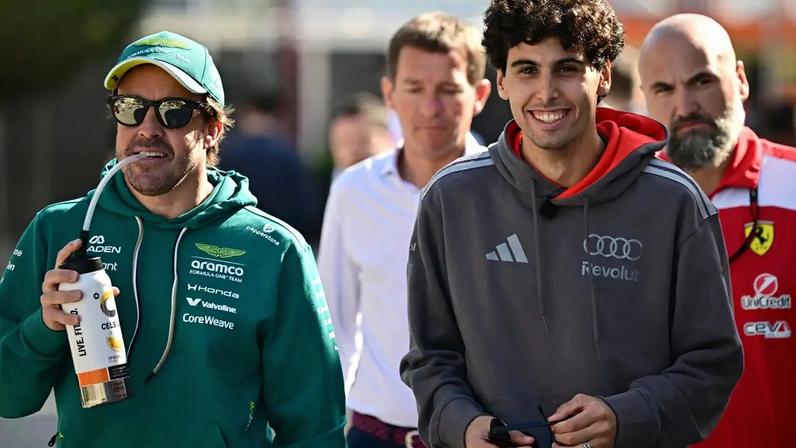 O espanhol da Aston Martin Fernando Alonso e o brasileiro da Audi Gabriel Bortoleto caminham pelo paddock no primeiro dia do segundo teste de pré-temporada da Fórmula 1 no Circuito Internacional do Bahrein, em Sakhir, em 18 de fevereiro de 2026 (Foto: Giuseppe cacace/afp)