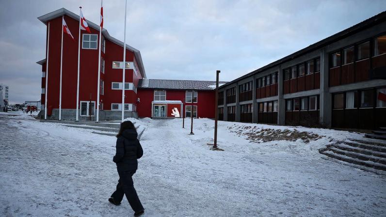 A person walks in front of the parliament in Nuuk, Greenland, February 2, 2026. REUTERS/Stoyan Nenov