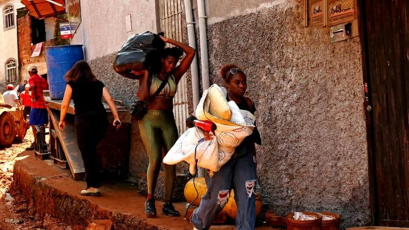 Residents carry away their belongings at the site where homes collapsed due to heavy rains and flooding in the Parque Burnier neighborhood of Juiz de Fora, Minas Gerais state, Brazil, Wednesday, Feb. 25, 2026. Photo courtesy of Silvia Izquierdo/ Associated Press