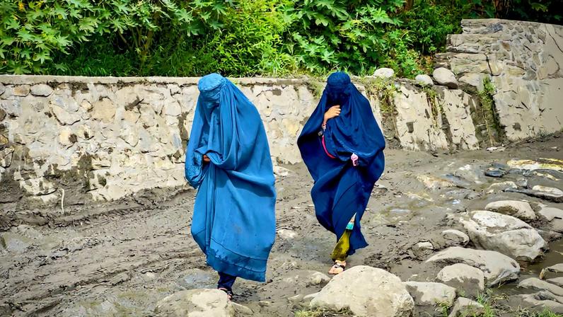 Afghan women in burqa walk towards a safer place after their house was damaged following a deadly magnitude 6 earthquake that struck Afghanistan on Sunday, at Lulam village, in Nurgal district, Kunar province, Afghanistan, September 3, 2025. REUTERS/Sayed Hassib/File Photo/File Photo
