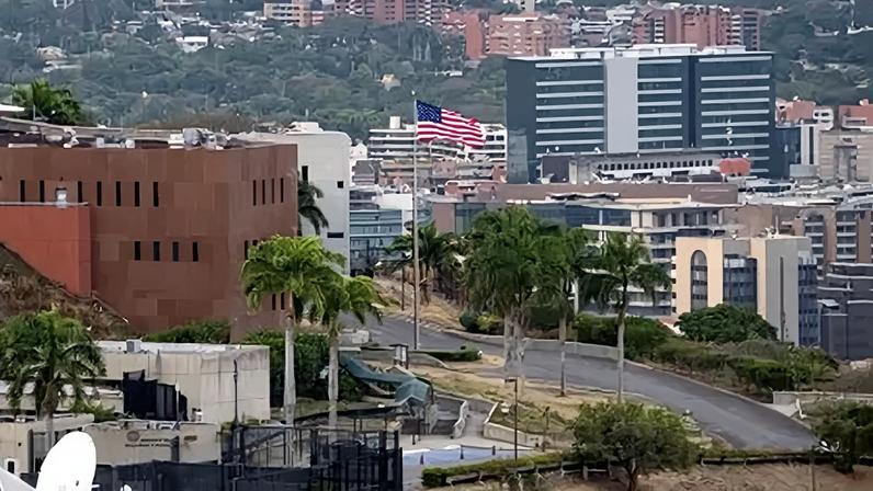 CARACAS, VENEZUELA - MARCH 14: The American flag is raised at the United States Embassy in the Venezuelan capital on March 14, 2026. This symbolic ceremony marks the formal resumption of direct diplomatic operations in Venezuela after a seven-year hiatus, coinciding with the anniversary of the departure of the last diplomatic mission in 2019. (Photo by Darwin Diko Canas/Anadolu via Getty Images)