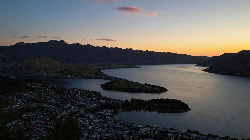 Sunset over Queenstown and lake Wakatipu, with the Remarkables range in the background.