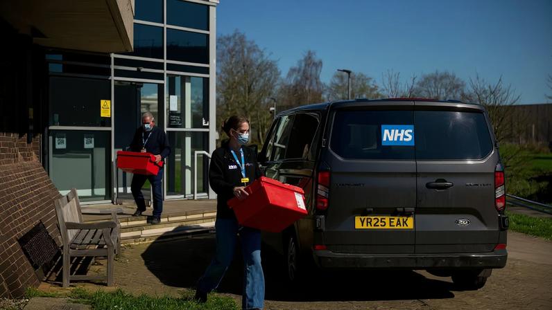 National Health Service (NHS) workers carry boxes from a building that is supplying antibiotics on the University of Kent campus following an outbreak of meningitis cases in Kent, in Canterbury, Britain, March 18, 2026. REUTERS/Chris J. Ratcliffe
