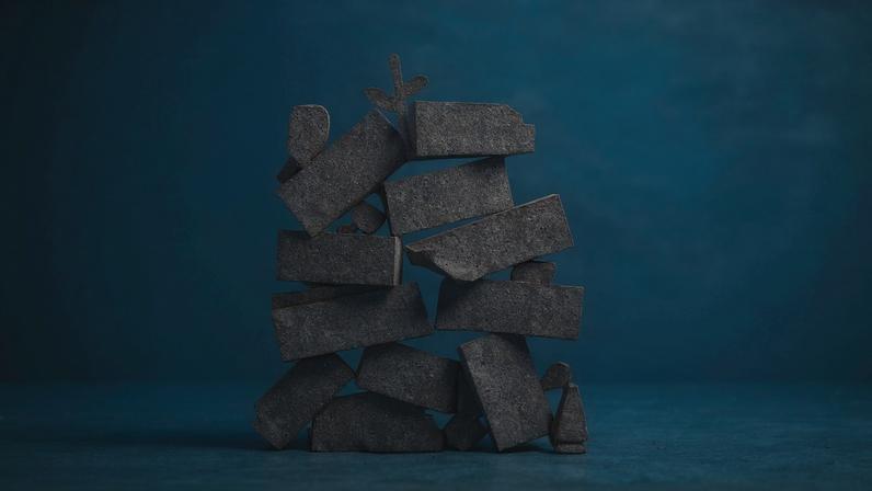 Illustration of a silhouette of a pile of debris with a flower growing from it.
