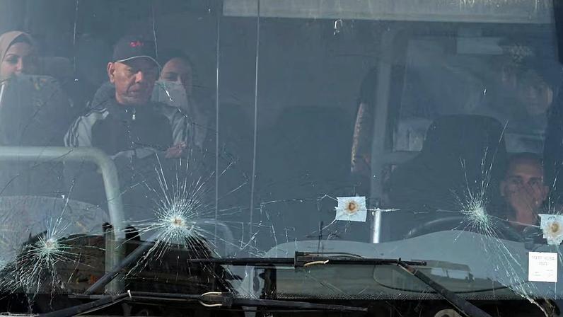 Palestinians sit in a bus as they get ready to leave Gaza through the Rafah border crossing, in the southern Gaza Strip
