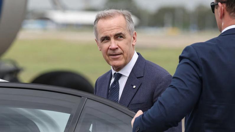 Canadian Prime Minister Mark Carney reacts as he enters a vehicle at Sydney Kingsford Smith Airport in Sydney, Australia, March 3, 2026. REUTERS/Hollie Adams