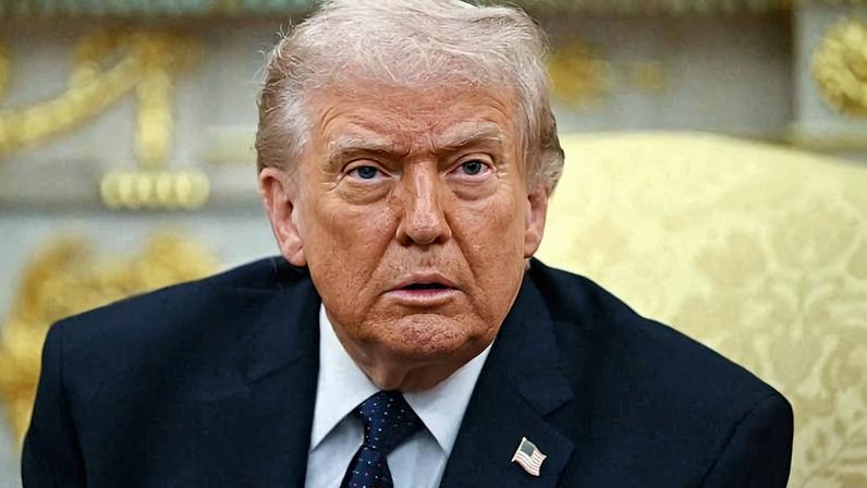 Donald Trump is seen staring while sitting in the Oval Office.