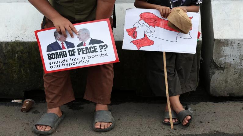 Boys in solidarity with Palestinians take part in a protest outside the U.S. embassy in Jakarta