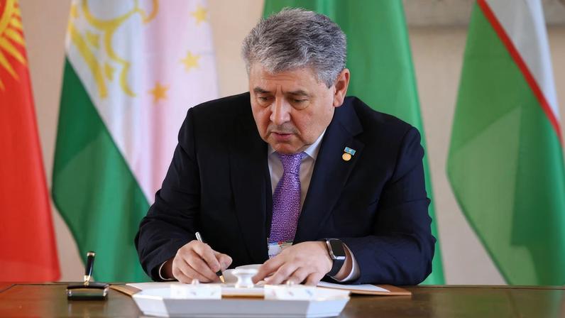 The foreign minister of Kazakhstan, Yermek Kosherbayev, signs a guestbook at Bellevue Palace in Berlin, Germany, February 11, 2026. REUTERS/Christian Mang