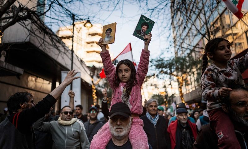 A girl holds a picture of slain Hezbollah leader Hassan Nasrallah in Beirut on March 8, during a protest against the ongoing Israel-Hezbollah hostilities.