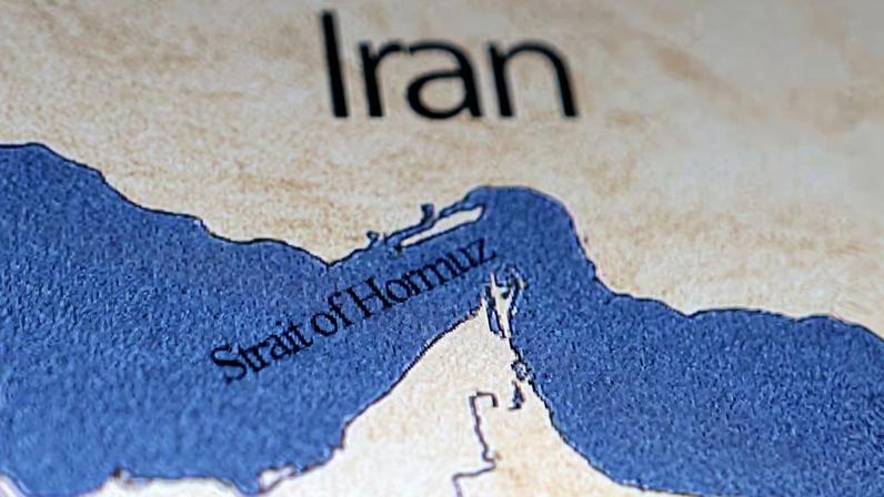 Illustration shows map showing the Strait of Hormuz and Iran
