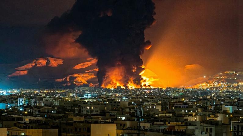 Smoke and flames rise at the site of airstrikes on an oil depot in Tehran.