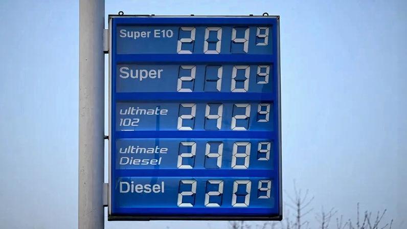 An illuminated display shows the prices at a gas station in Essen, Germany.