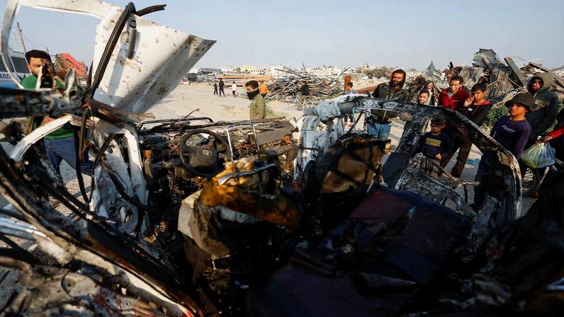 Palestinians inspect the site of an Israeli airstrike targeting a police vehicle in the central Gaza Strip, March 15, 2026. REUTERS/Mahmoud Issa