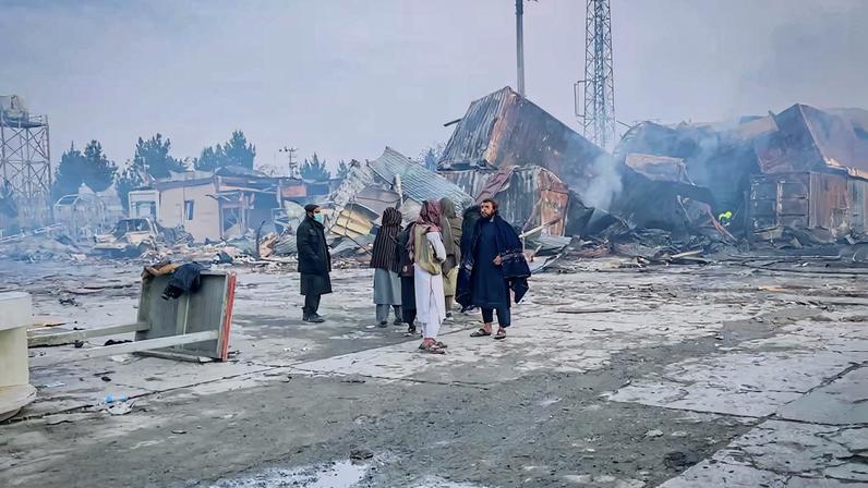 People stand next to a drug users rehabilitation hospital destroyed in what the Taliban said was a Pakistani air strike, in Kabul, Afghanistan, March 17, 2026. REUTERS/Sayed Hassib