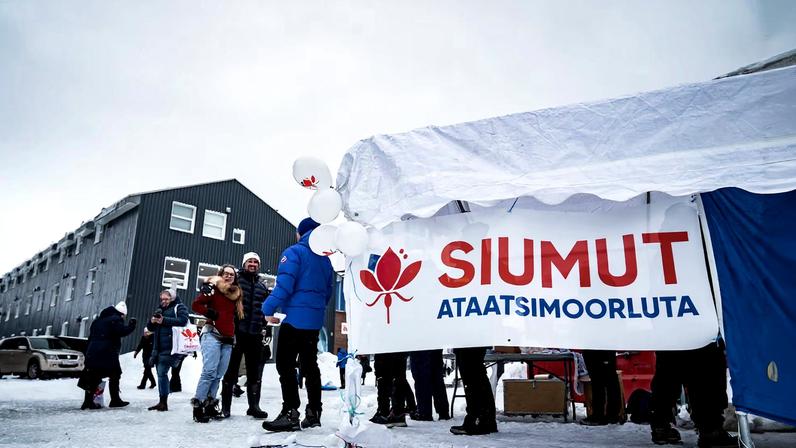 Candidates from the Greenlandic party Siumut pass out flyers in Nuuk, Greenland March 31, 2021 Ritzau Scanpix/Emil Helms via REUTERS/ File Photo