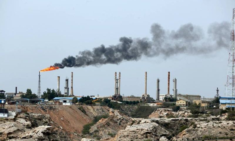 An oil facility in the Persian Gulf expelling fire and smoke.
