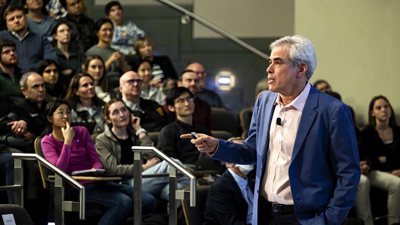 Jonathan Haidt speaks to a full audience in stadium-style seating