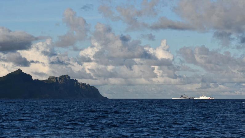 A China Coast Guard vessel sails near a Japan Coast Guard vessel around a group of disputed islands called Senkaku Islands in Japan, also known in China as Diaoyu Islands