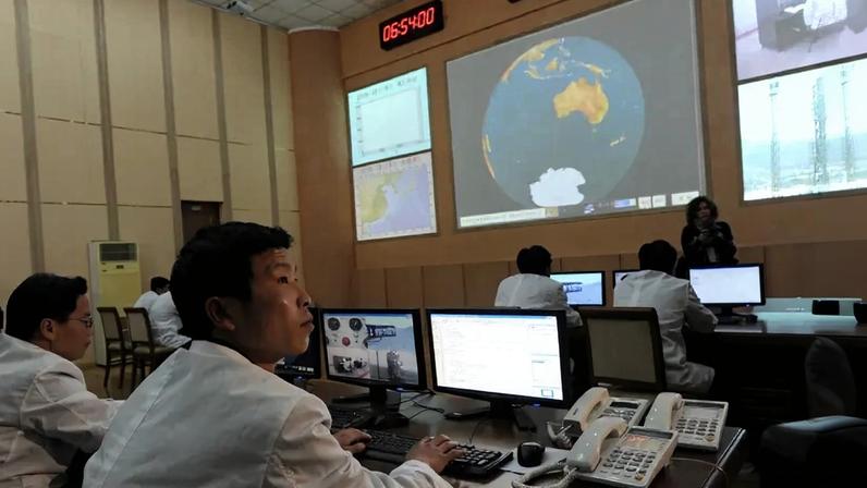 North Korean technicians work in the control room of the Tongchang-ri space center on April 8, 2012.