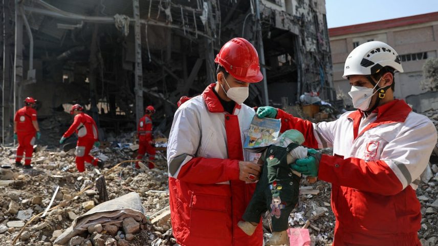 Members of a Red Crescent rescue team hold a doll, at the site of a building that was damaged by a strike, amid the U.S.-Israeli conflict with Iran, in Tehran, Iran, March 17, 2026. Majid Asgaripour/WANA (West Asia News Agency) via REUTERS