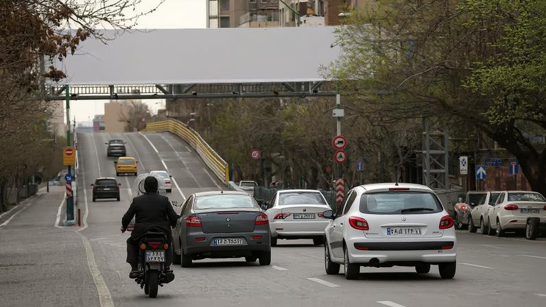 People drive near a banner of Iran's late Supreme Leader Ayatollah Ali Khamenei on a street, after he was killed in Israeli and U.S. strikes on Saturday, in Tehran, Iran, March 2, 2026. Majid Asgaripour/WANA (West Asia News Agency) via REUTERS
