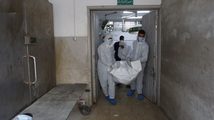 Forensic experts carry a body out of the morgue at al-Shifa hospital in Gaza City on January 30, 2026. As part of the Gaza ceasefire deal, bodies of Palestinians were returned by Israel the previous day.