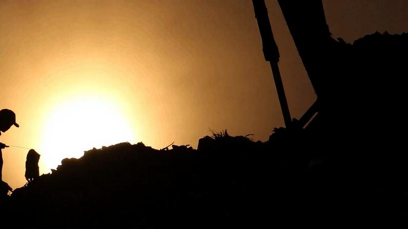 An excavator collects garbage at the Bantargebang Integrated Waste Disposal Site.