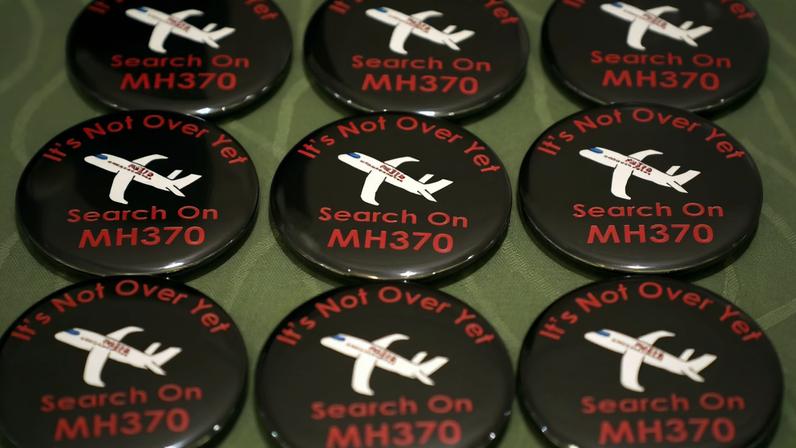 Badges are displayed during a remembrance event for the missing Malaysia Airlines flight MH370 in Putrajaya, Malaysia, March 7, 2020. REUTERS/Lim Huey Teng/File Photo