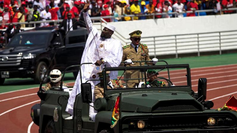 Guinea's President-elect Mamady Doumbouya arrives in a vehicle to take the oath of office during a swearing-in ceremony in Conakry