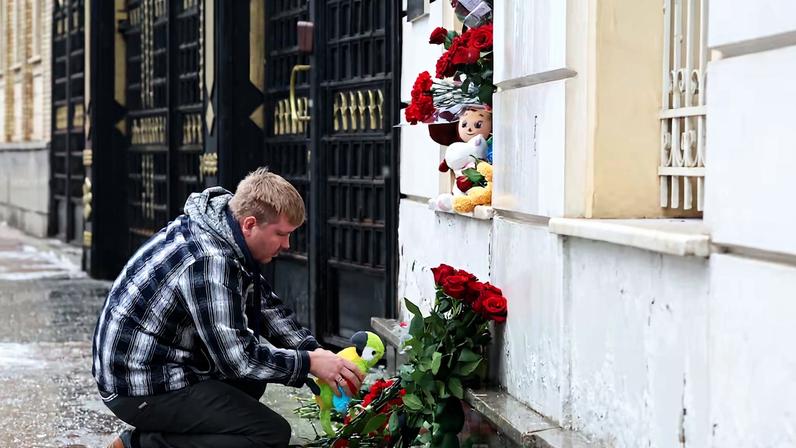 People bring flowers and toys to the Iranian embassy in Moscow