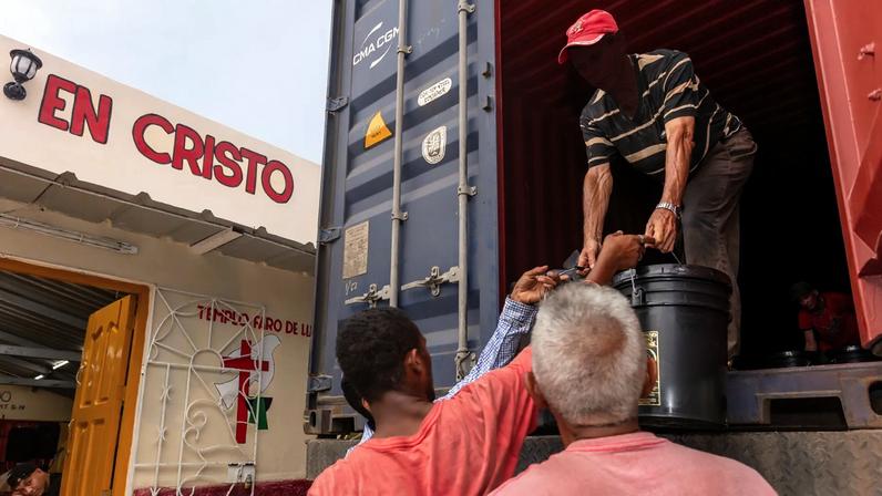 Members of the Iglesia Hermanos en Cristo Faro de Luz unloading supplies that will be distributed to people in the church and the community.