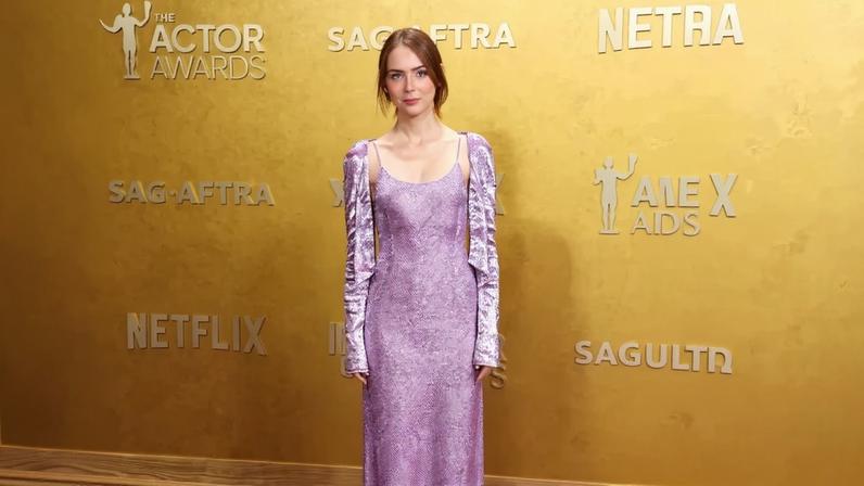 Emma Stone arrived at the SAG Actor Awards 2026 on Sunday in a custom Louis Vuitton lilac slip dress with a matching beaded cardigan.