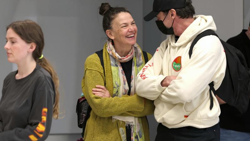 Hugh Jackman and Sutton Foster smiling at each other.