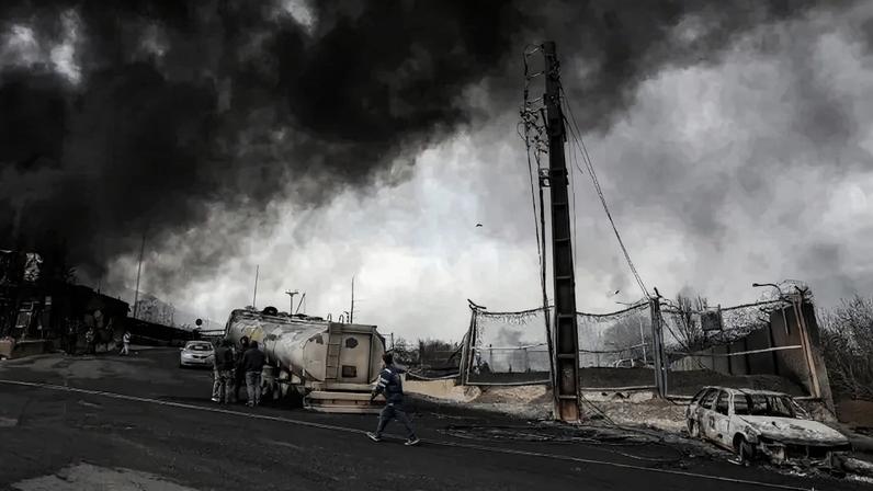Dark smoke clouds following an overnight airstrike on the Shahran oil refinery in northwestern Tehran on March 8.
