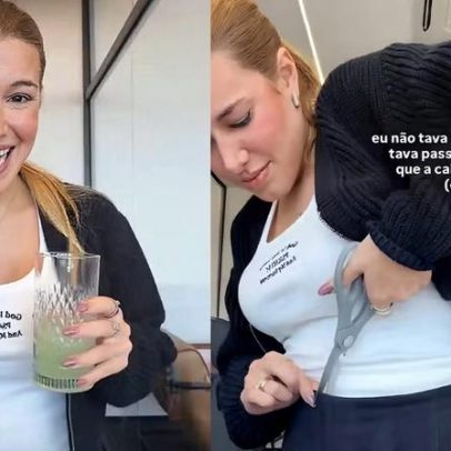 Grávida nora de Elaine Mickely corta cós de moletom com tesoura por aperto